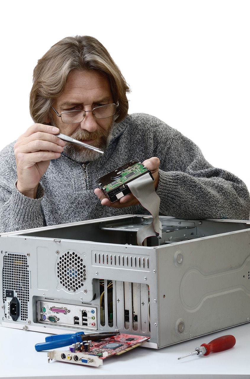 A technician closely inspecting a circuit board during a repair